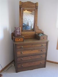 Antique dresser with glove boxes and mirror.