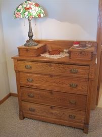 Old dresser. Tiffany style lamp.