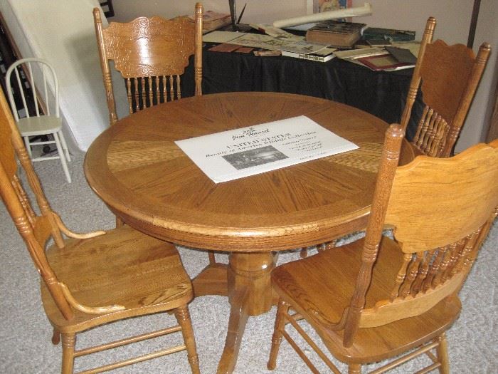 Pedestal table with 4 press back chairs.