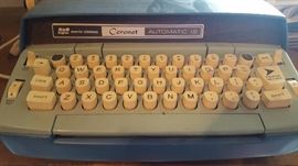 one of several vintage typewriters, including n old remington typewriter
