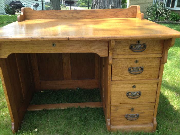 Antique solid oak desk. Five drawers, desk is finished on all sides.