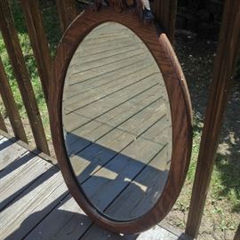 Vintage dark oak framed oval mirror.  Measures:  28 1/2" H X 16 1/2" W.