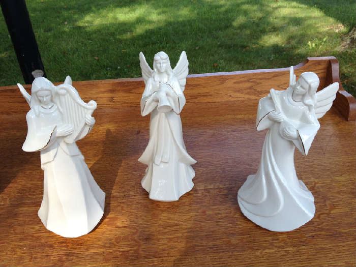 Three Mikasa angels playing musical instruments.  Measures:  10 1/2" H.  Creamy white color. Excellent condition.