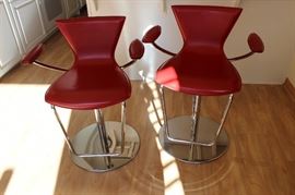 Two red leather contemporary bar stools. Italian.