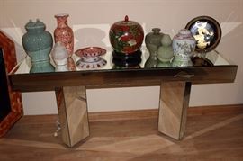 Mirrored sofa table and selection of ceramics.