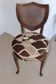 Giraffe needlepoint and cane back chair.