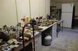 Tools, fridge freezer, gas tank, fridge freezer, boxes of wine glasses.