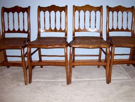                 Set of four spindle back caned side chairs