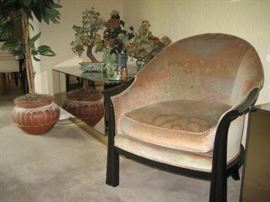 Upholstered chair and jade trees on mirrored end table