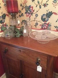 Antique wash stand; antique cranberry lamp; cake stand