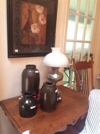 Antique table, jugs, and lamp
