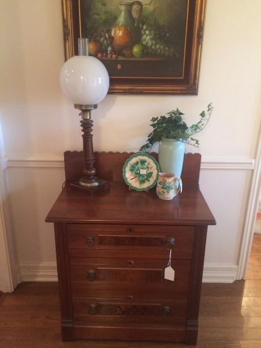 Antique washstand/chest; vintage lamp; oil still-life of fruit