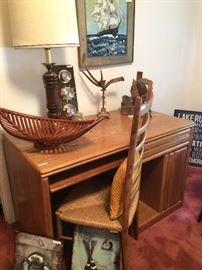 Computer desk; ladder back chair; sailing ship art