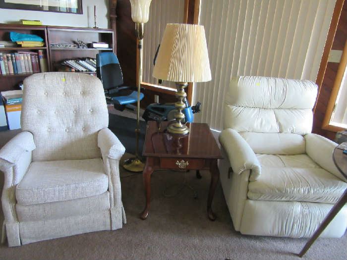 The recliner chairs. The one on the right is leather and the one on the left is upholstery.  End table and lamps similar to this one are in the sale. 