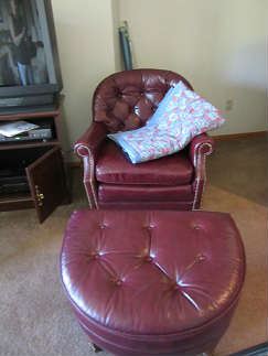 The burgundy leather chair and ottoman.  the Quilt over the chair is in the sale.