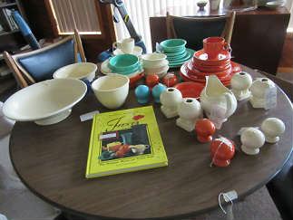 Fiesta Ware  Many early colors and pieces, Others from the 50's.  The book is dated 1996.  The table the pieces are on has two levels. It can be at normal table level or be reduced to coffee table level. It comes with 6 chairs, two are folding.  