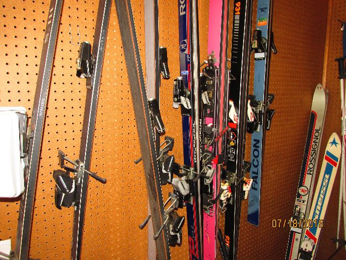 assortment of snow skis, various brands