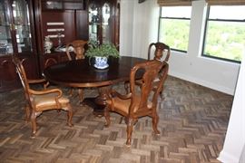 Light walnut table with 4 arm chairs.