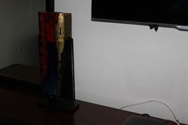 Glass art in metal stand.