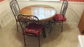 Small wrought iron/wood kitchen table with four chairs, and a glass top