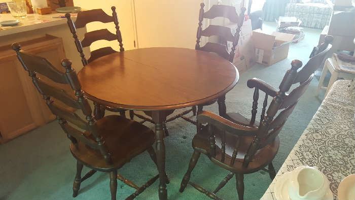 Round table with four chairs and two extra leaves - $100
