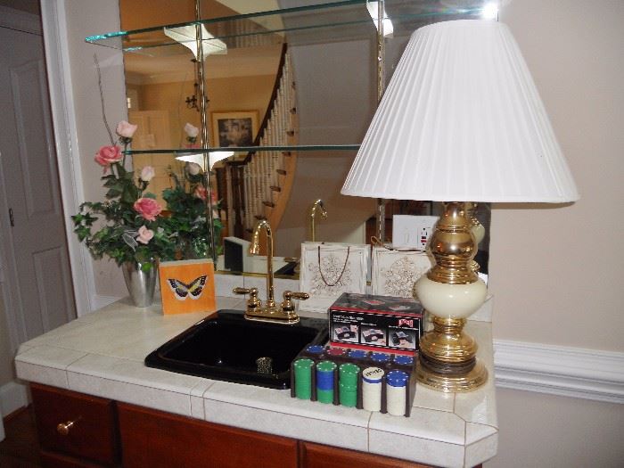 Brass lamp, poker chips and home decor