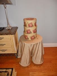 3 stacked hat boxes on round table with custom skirt