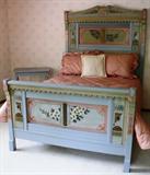 Painted cottage-style bed with original floral painting circa 1890. This is part of a four-piece set including commode, dresser and table all with the same paint.