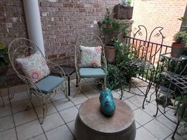 Very nice outdoor patio, filled with vintage and contemporary furniture, pots and plants.