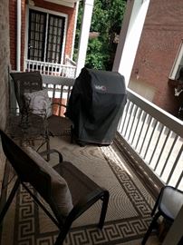 Another patio, another pair o' chairs and a nicely cared- for Weber grill. Oh, and don't forget the fetching Greek key bordered outdoor rug!