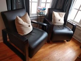 Pair of black leather (kinda S & M lookin') armchairs in the master bedroom. If those things could talk...