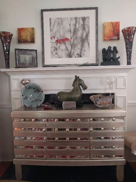 Very nice mirrored/silver-leafed buffet, that matched the dining table.                                                                         Above the mantle, a nicely framed/matted print, by Atlanta artist, Marilyn Suriani.  http://www.surianiphoto.com/