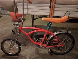 OK, now this is when it get's REAL. When's the last time you saw a very good version of this Schwinn "Orange Krate" Sting Ray, glitter banana-seat, sissy bar and flared chrome fender? This thing weighs in at 45 pounds, is a 1998 reissue of the original 1972 edition.