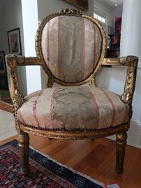 One of a pair of vintage French gilt armchairs - they are quite substantial and heavy!