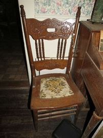 One of the chairs belonging to antique dining table