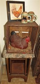 Ceramic hen in coop on antique step stool.