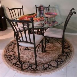 Round iron and glass top table - handmade rug