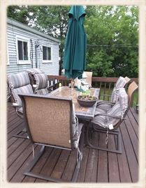 Stone tile top patio table with chairs and umbrella