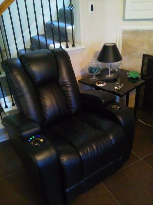 lamp, glass art, black leather recliner chair with electric function switches, black glass end tables fireplace screen