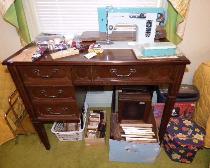 White sewing machine in cabinet, sewing items