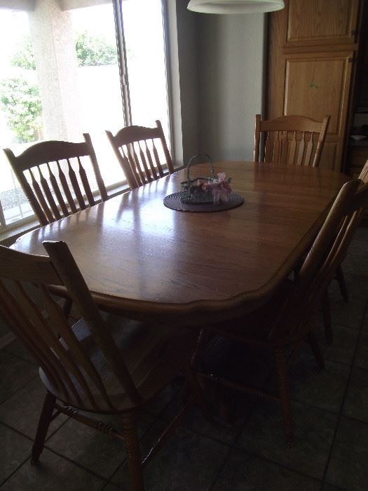 large oak table and chairs with extra leaf