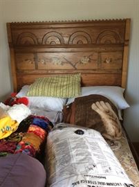 Beautiful high back bed with painted flowers and lots of bedding.