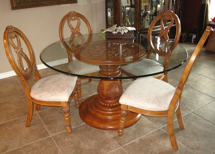 (Closer look) Beautiful 72" Bevel Edge Glass Top Table on a 30" Wood Base.  Top has Inset Applied Wood Decor with Acanthus Leaf Decorated Column Base. Set of 4 Matching Chairs with Upholstered Seat, Carved Banjo Back with Turned Legs.