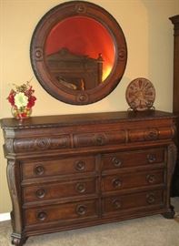T.S. Berry Hillsboro Wellesley Burnish Walnut with Burl Panels 9 Drawer Dresser (66"W x 23"D x 43"H) complete with a Matching 42 Diameter Bevel Mirror.