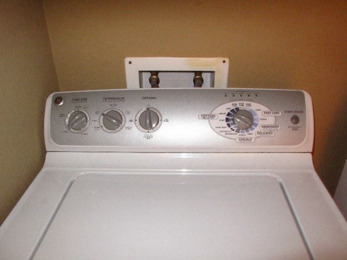 Top view of GE White Stainless Tub King Size Capacity Top Loader Washer.  Roper Large Capacity White Electric Dryer