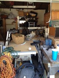 tools, cords, work bench, saws, tools, ladder, racks, vacuum 