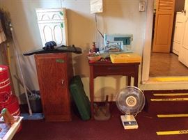 Singer sewing machine with cabinet in garage