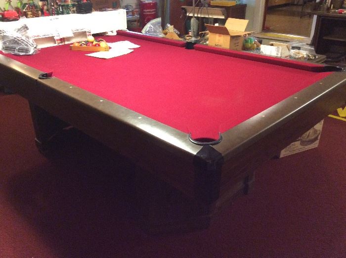 Full view if pool table & rack of balls. Slate tabletop on this 