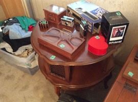 Tiered table, cameras, men's vanity with drawer. Men's shirts, tshirts, etc - big & tall sizes. Some Harley Davidson T shirts