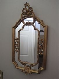 Gold framed mirror.